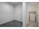 Empty room with an adjacent laundry room with washer and dryer at 4032 Little Bay Ave, North Las Vegas, NV 89081