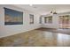 Bright living room featuring modern tile flooring, ceiling fan, and access to the patio at 4032 Little Bay Ave, North Las Vegas, NV 89081