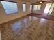 Open living area with neutral tile flooring and large windows providing natural light and backyard views at 4032 Little Bay Ave, North Las Vegas, NV 89081