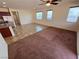 Open-concept living room featuring hard surface flooring and carpeting, with a ceiling fan, and ample natural light at 4032 Little Bay Ave, North Las Vegas, NV 89081