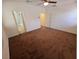 Large carpeted bedroom with connecting bath and walk-in closet featuring neutral walls, and ceiling fan at 4032 Little Bay Ave, North Las Vegas, NV 89081