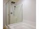 Modern glass enclosed shower with dual shower heads adjacent to the large soaking tub at 4032 Little Bay Ave, North Las Vegas, NV 89081