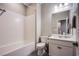 Clean, standard bathroom design showcasing a tub and shower combination, toilet, and vanity with a sink and countertop at 4533 Queens Hill St, North Las Vegas, NV 89031