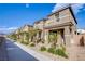 Charming row of two-story townhomes with well-manicured landscaping and covered entryways at 4533 Queens Hill St, North Las Vegas, NV 89031