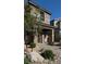 Inviting townhome exterior with a paved walkway, covered entrance, and desert-friendly landscaping at 4533 Queens Hill St, North Las Vegas, NV 89031