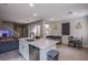 Open-concept kitchen with white cabinets, stainless steel appliances, and a central island at 4533 Queens Hill St, North Las Vegas, NV 89031