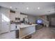 Modern kitchen featuring white cabinets, stainless steel appliances and an island with a sink at 4533 Queens Hill St, North Las Vegas, NV 89031