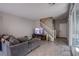 Inviting living room with a comfortable gray couch and wood-look tile flooring at 4533 Queens Hill St, North Las Vegas, NV 89031