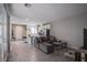 Open-concept living room with tile flooring, modern furnishings, and abundant natural light at 4533 Queens Hill St, North Las Vegas, NV 89031