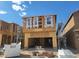 Exterior view of home in the framing stage of construction with open garage at 10026 Indy Rey Ct, Las Vegas, NV 89148