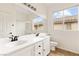 Bright bathroom with double sinks, tub/shower combo, and a large mirror, perfect for a quick refresh at 10393 Trailing Dalea Ave, Las Vegas, NV 89135
