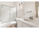 Bathroom features a tub with shower, toilet, and single sink with ample counter space at 10393 Trailing Dalea Ave, Las Vegas, NV 89135