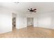 Open-concept bedroom featuring tile flooring, ceiling fan and hallway access at 10393 Trailing Dalea Ave, Las Vegas, NV 89135