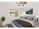 Well-lit bedroom with large window, soft rug, and neutral tones for a relaxing ambiance at 10393 Trailing Dalea Ave, Las Vegas, NV 89135