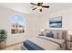 Comfortable bedroom with a soft rug, neutral tones, and arched window providing ample natural light at 10393 Trailing Dalea Ave, Las Vegas, NV 89135