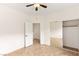Spacious bedroom features tile flooring, ceiling fan, and large mirrored closet doors at 10393 Trailing Dalea Ave, Las Vegas, NV 89135