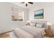 Comfortable bedroom with a soft rug, neutral tones, and large windows providing ample natural light at 10393 Trailing Dalea Ave, Las Vegas, NV 89135