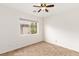 Well-lit bedroom with a ceiling fan and tile flooring at 10393 Trailing Dalea Ave, Las Vegas, NV 89135