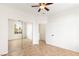 Bedroom featuring tile flooring, ceiling fan, mirrored closet doors and access to hallway at 10393 Trailing Dalea Ave, Las Vegas, NV 89135