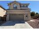 Two-story home with a two car garage and a well-maintained front yard at 10393 Trailing Dalea Ave, Las Vegas, NV 89135