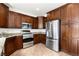 Kitchen featuring stainless steel appliances, granite countertops, and dark wood custom cabinets at 10393 Trailing Dalea Ave, Las Vegas, NV 89135
