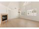 Living room featuring a fireplace, large windows with shutters, and hardwood floors at 10393 Trailing Dalea Ave, Las Vegas, NV 89135