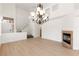 Spacious living area with a fireplace, hardwood floors, and staircase at 10393 Trailing Dalea Ave, Las Vegas, NV 89135