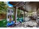 Inviting backyard patio with outdoor seating, playhouse, and lush landscaping at 10433 Mount Washington Ave, Las Vegas, NV 89166
