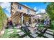 Spacious backyard boasts a covered patio, fire pit, and lush landscaping, creating a relaxing outdoor oasis at 10433 Mount Washington Ave, Las Vegas, NV 89166