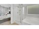Bright bathroom with double vanity, tub, glass shower, and access to main bedroom at 10433 Mount Washington Ave, Las Vegas, NV 89166