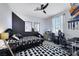 The gamer themed bedroom has a desk and chair and a black accent wall at 10433 Mount Washington Ave, Las Vegas, NV 89166