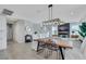 Open-concept design with a dining area, wood table, and contemporary lighting fixture at 10433 Mount Washington Ave, Las Vegas, NV 89166