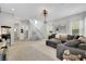 Open-concept entertainment room with projector, large sectional, and backyard access at 10433 Mount Washington Ave, Las Vegas, NV 89166