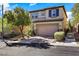 Charming two-story home featuring a tile roof, attached garage, and manicured landscaping at 10433 Mount Washington Ave, Las Vegas, NV 89166