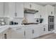 Elegant kitchen with white cabinetry, herringbone backsplash, and stainless steel appliances at 10433 Mount Washington Ave, Las Vegas, NV 89166