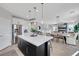 Open kitchen showcasing an island with seating and seamless transition into the living room at 10433 Mount Washington Ave, Las Vegas, NV 89166