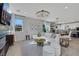Bright living room with a plush white sofa, stylish decor, and open layout at 10433 Mount Washington Ave, Las Vegas, NV 89166
