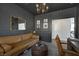 Stylish living room featuring painted brick wall, modern light fixture, and comfortable seating at 10433 Mount Washington Ave, Las Vegas, NV 89166
