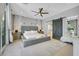 Luxurious main bedroom featuring a plush bed, barn door to bath, and plenty of light at 10433 Mount Washington Ave, Las Vegas, NV 89166