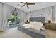 Luxurious main bedroom with stylish gray furniture, tufted headboard, and backyard access at 10433 Mount Washington Ave, Las Vegas, NV 89166