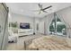 Bright main bedroom features a ceiling fan, a TV, and sliding doors to the backyard patio at 10433 Mount Washington Ave, Las Vegas, NV 89166