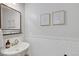 Stylish powder room with decorative mirror, wall art and tiled backsplash at 10433 Mount Washington Ave, Las Vegas, NV 89166