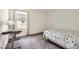 Cozy bedroom with plush carpet, writing desk, and a window providing natural light at 10663 Sariah Skye Ave, Las Vegas, NV 89166