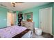 Bright bedroom with a bed, a dresser with mirror, storage shelves, and a neutral-toned carpet at 10663 Sariah Skye Ave, Las Vegas, NV 89166
