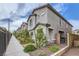 Charming townhome exterior with landscaped front yard, sidewalk and wrought iron fence at 10663 Sariah Skye Ave, Las Vegas, NV 89166