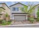 Two-story home with gray garage door, brick driveway, and well-kept landscaping at 10663 Sariah Skye Ave, Las Vegas, NV 89166