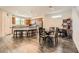 Open kitchen with a dining table, island with seating, wooden cabinets, and stainless steel appliances at 10663 Sariah Skye Ave, Las Vegas, NV 89166