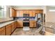 Stylish kitchen with wooden cabinets, granite countertops, stainless steel appliances and backsplash at 10663 Sariah Skye Ave, Las Vegas, NV 89166