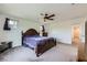 Primary bedroom showcasing a bed, a ceiling fan, two windows, and neutral-toned carpet at 10663 Sariah Skye Ave, Las Vegas, NV 89166