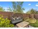 Comfortable seating area in backyard with artificial grass and privacy wall at 11315 Gravitation Dr, Las Vegas, NV 89135